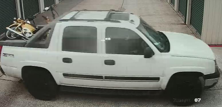 Photo of white 4-door Chevy Avalanche Z66 loaded with what appears to be workout bikes and a moped. 